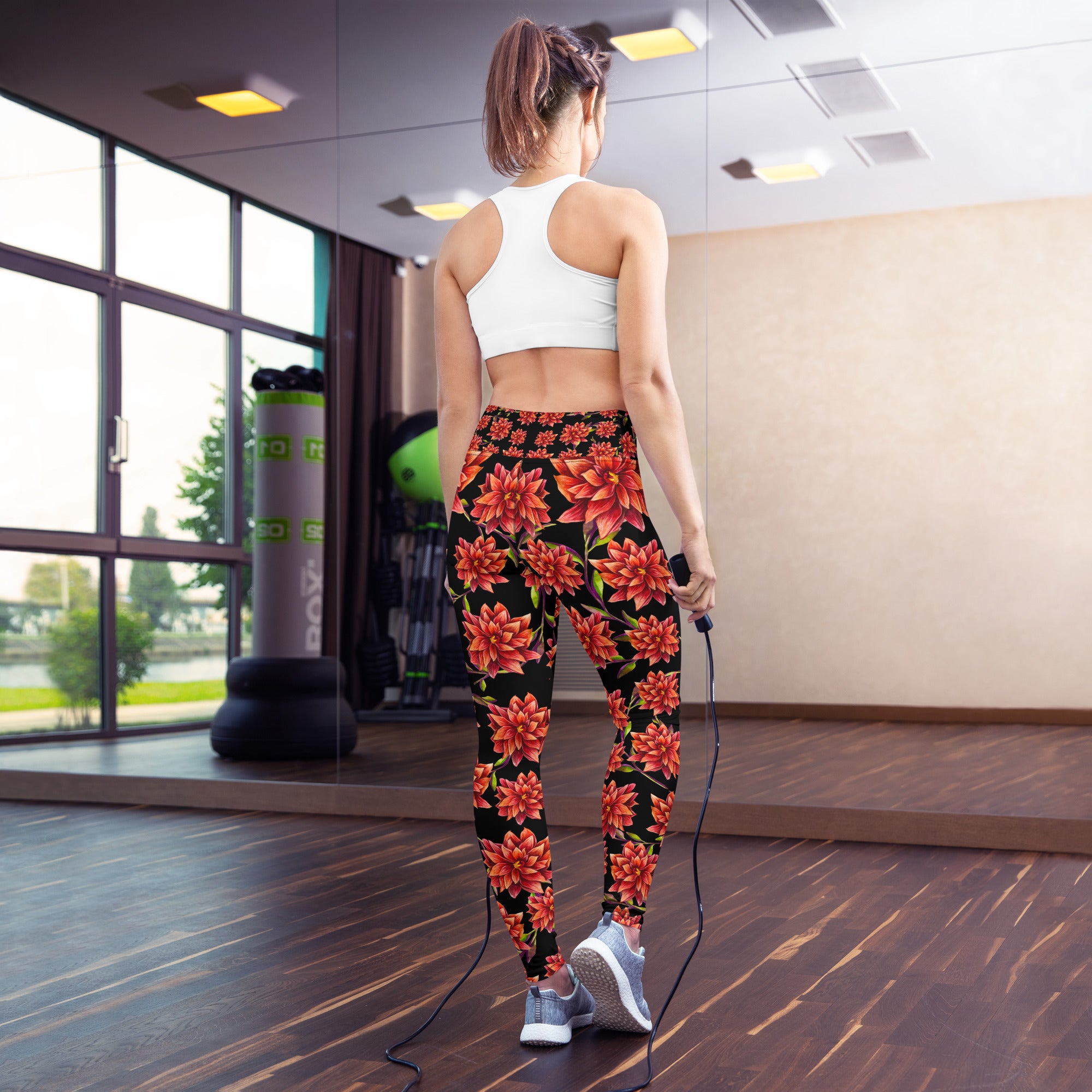 Women's high-waist yoga leggings featuring a bold red floral print on a black background. Stylish, stretchy, and designed for yoga, workouts, and everyday activewear